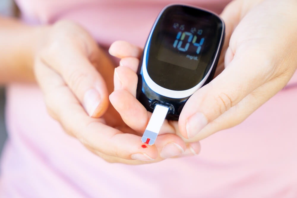 Woman measuring blood sugar insulin resistance reversal