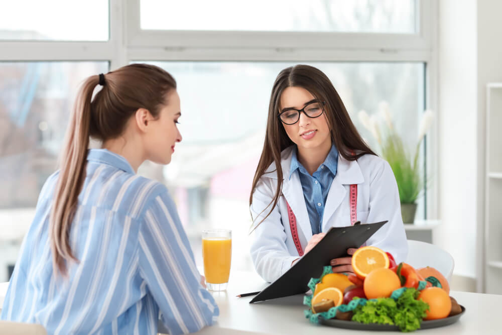 Female nutritionist with patient nutritional epigenetics